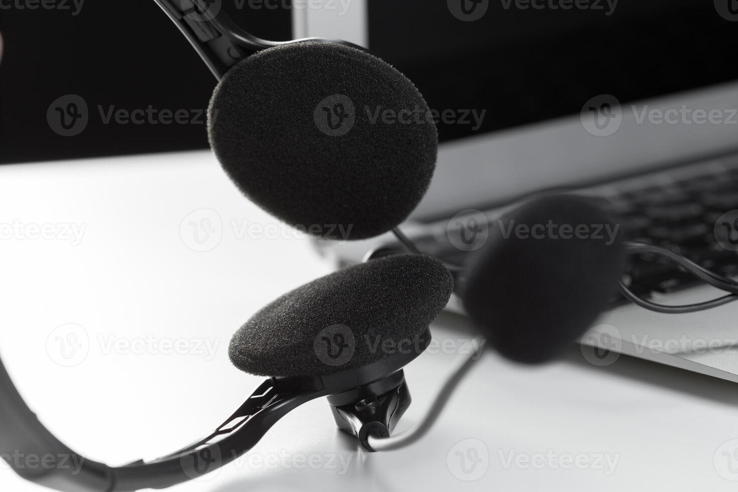 call center support concept. headset on keyboard computer laptop photo