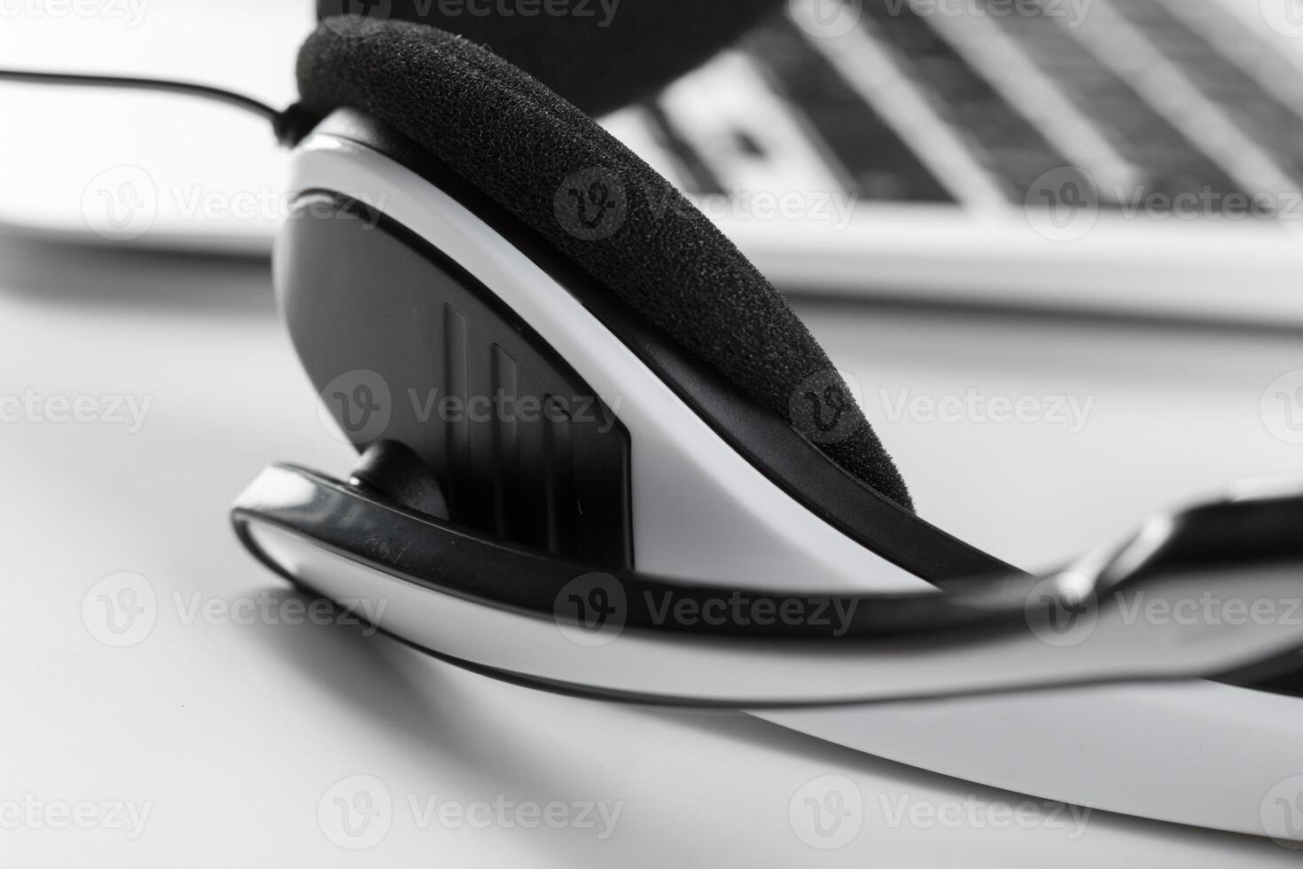 call center support concept. headset on keyboard computer laptop photo