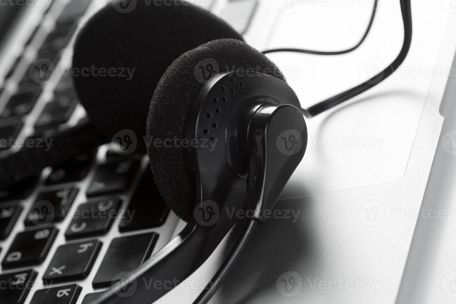 call center support concept. headset on keyboard computer laptop photo