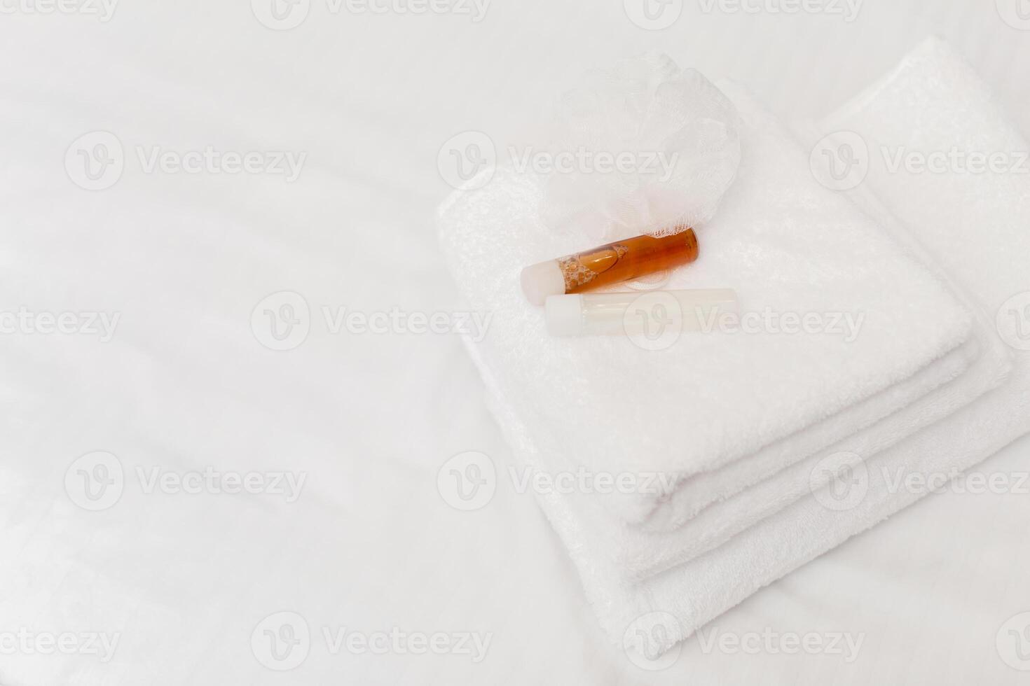 Clean towels on bed at hotel room photo
