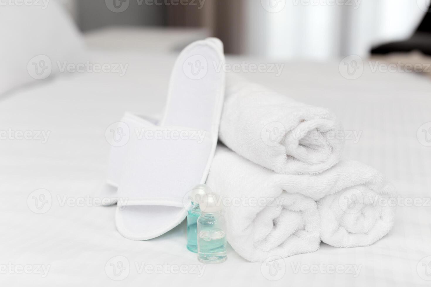 Clean towels on bed at hotel room photo