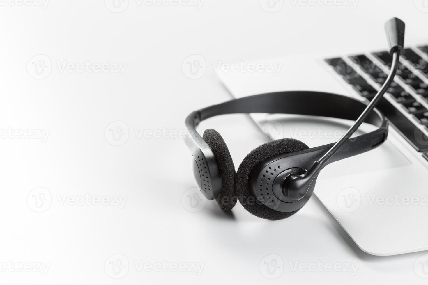 call center support concept. headset on keyboard computer laptop photo
