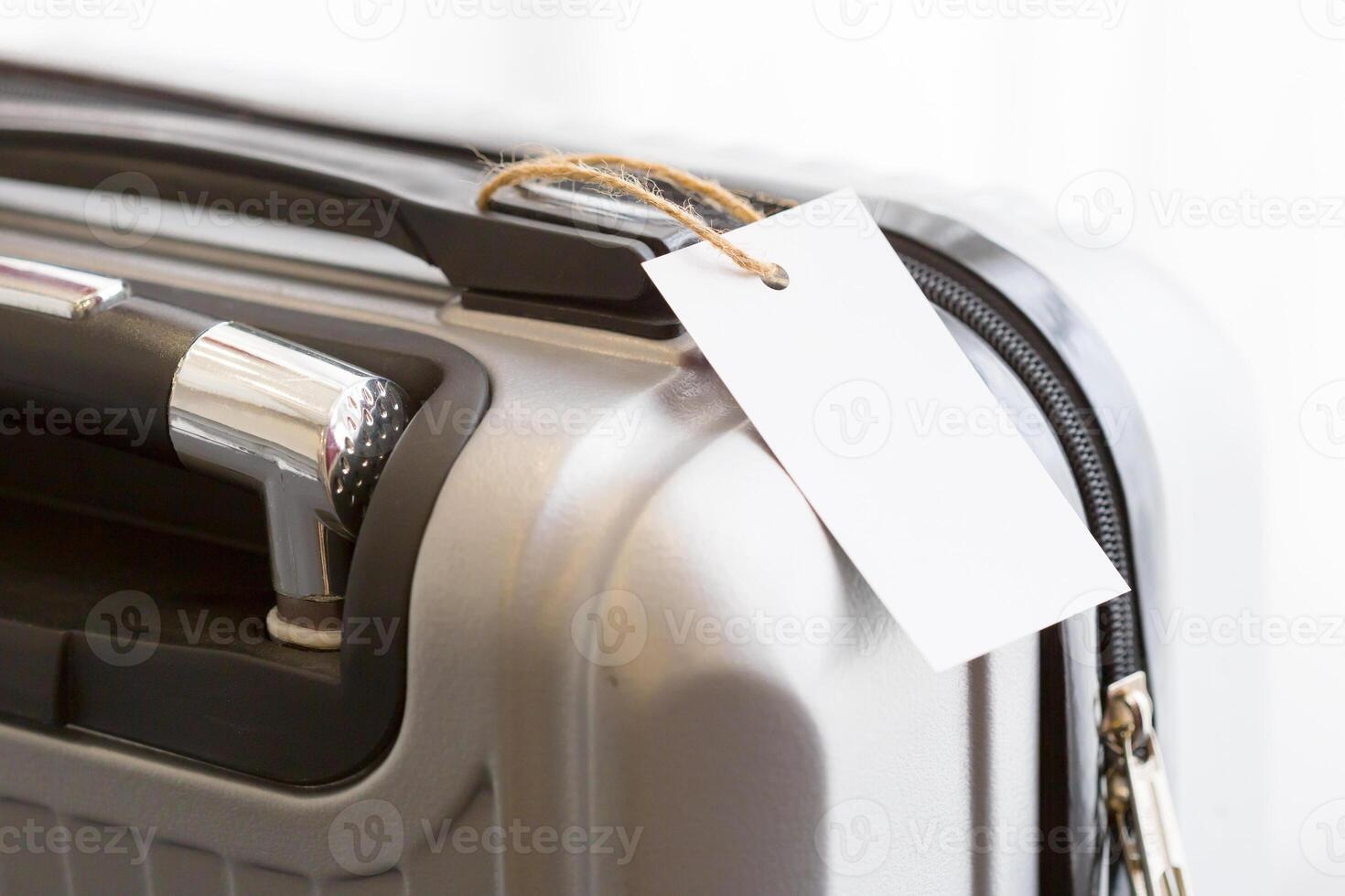 Close up of blank luggage tag label on a suitcase photo