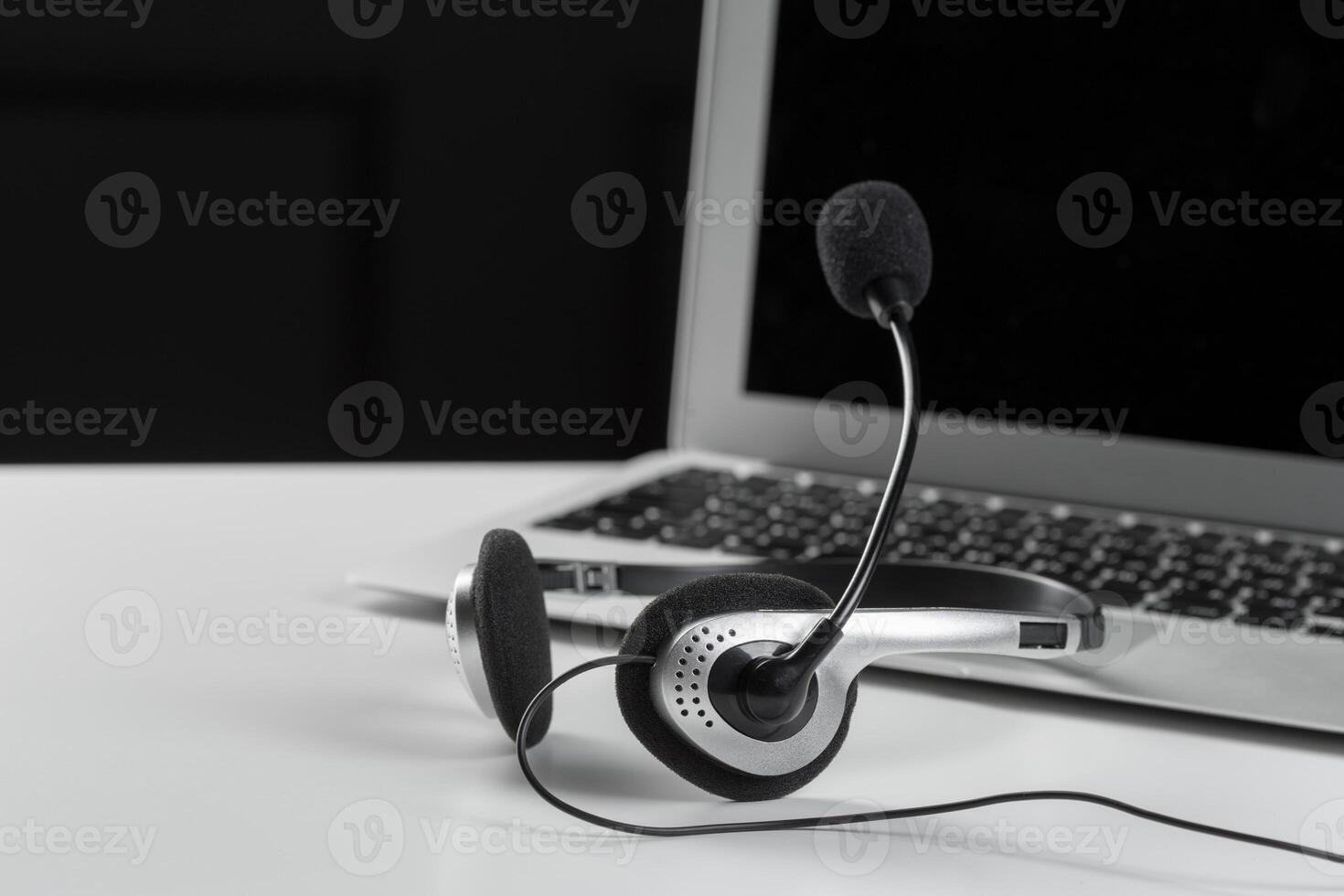 call center support concept. headset on keyboard computer laptop photo