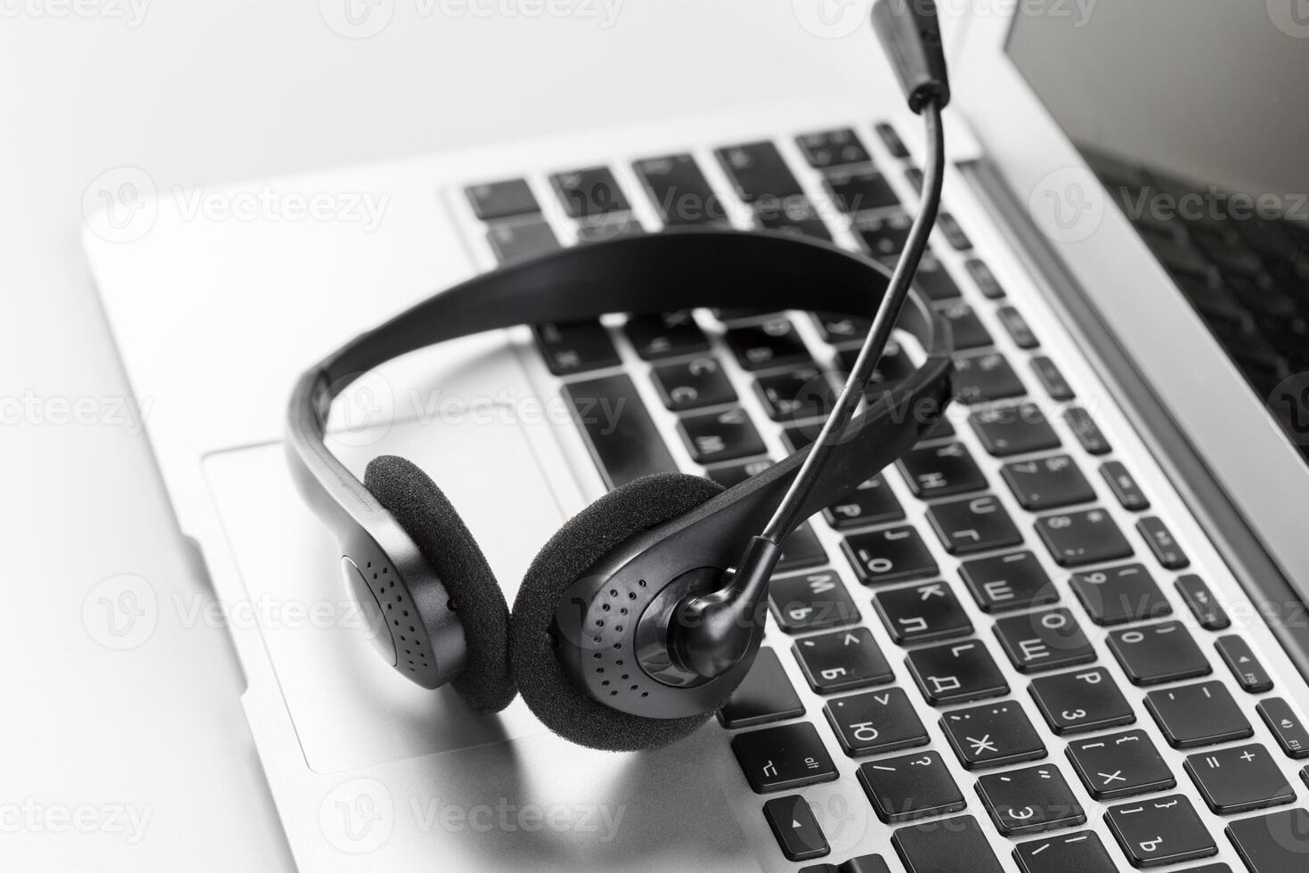 call center support concept. headset on keyboard computer laptop photo