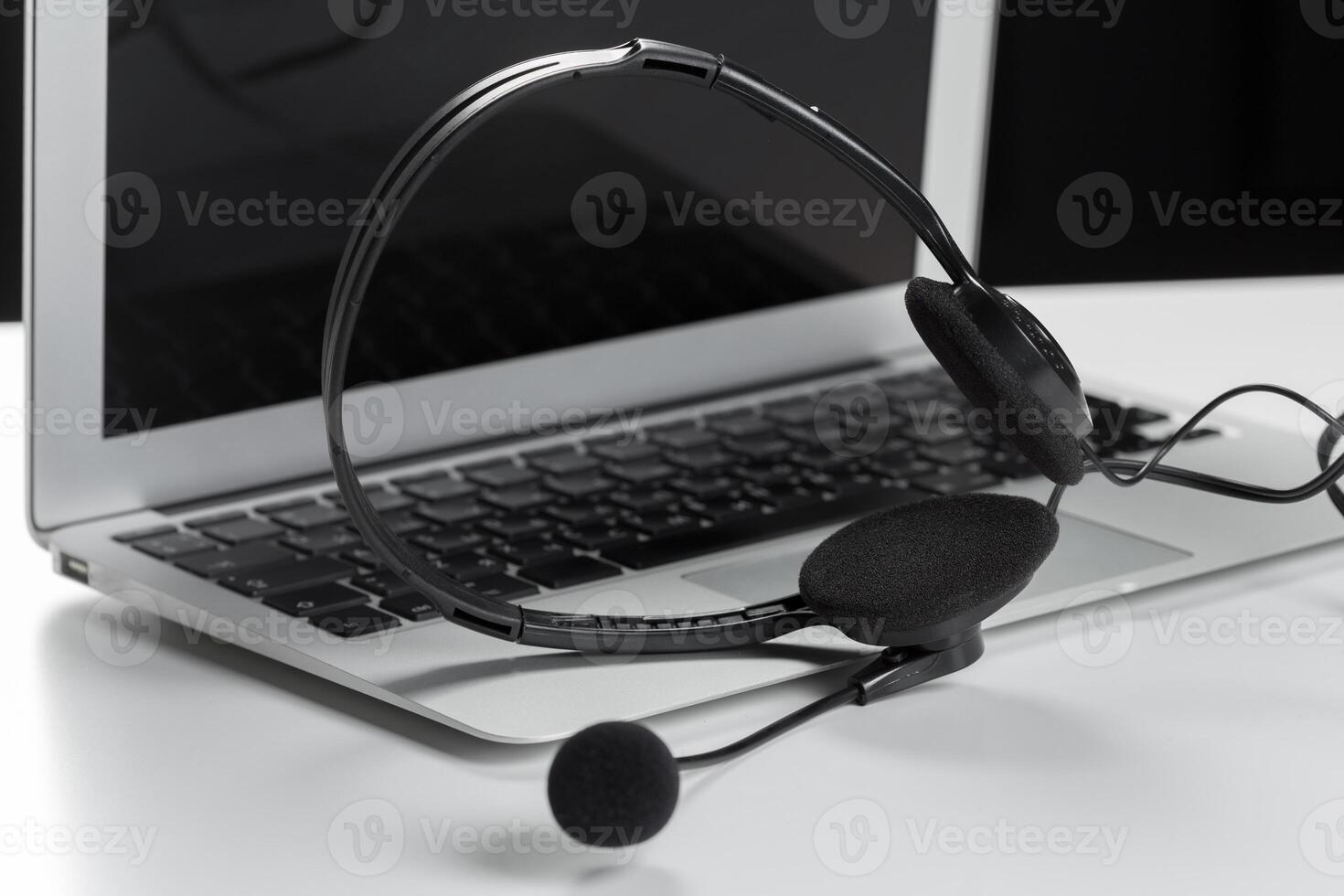 call center support concept. headset on keyboard computer laptop photo