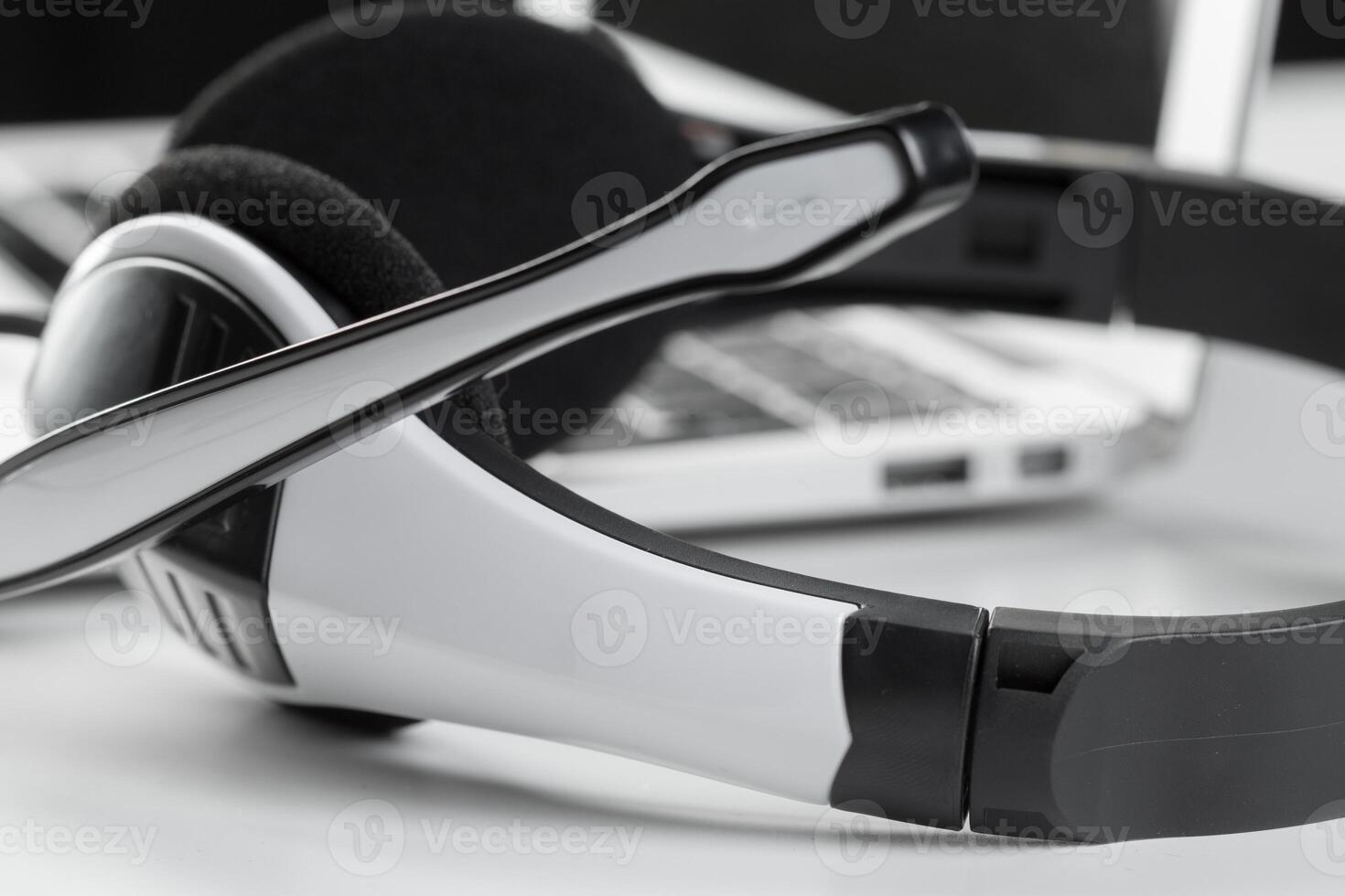call center support concept. headset on keyboard computer laptop photo