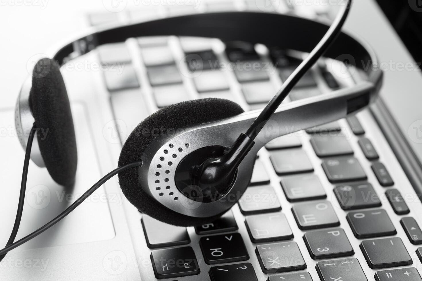 call center support concept. headset on keyboard computer laptop photo