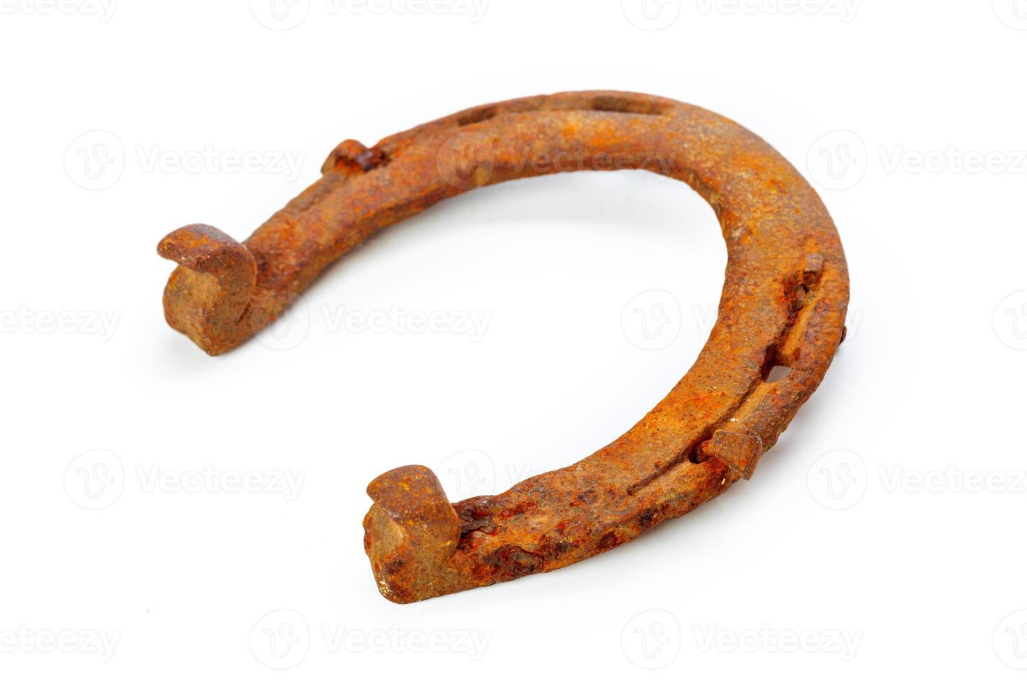 Old rusty horseshoe isolated on white photo