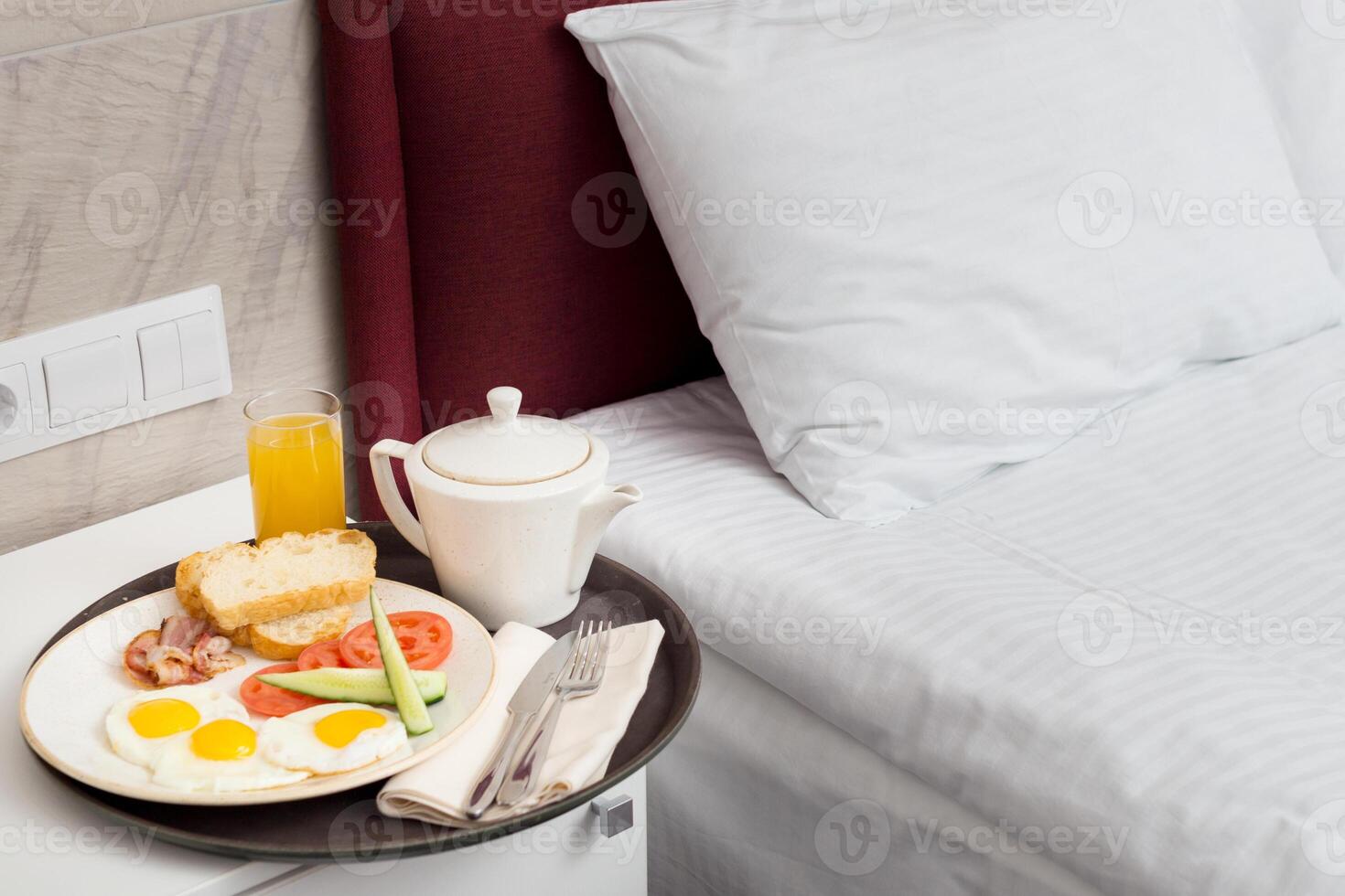 Breakfast in bed in hotel room photo