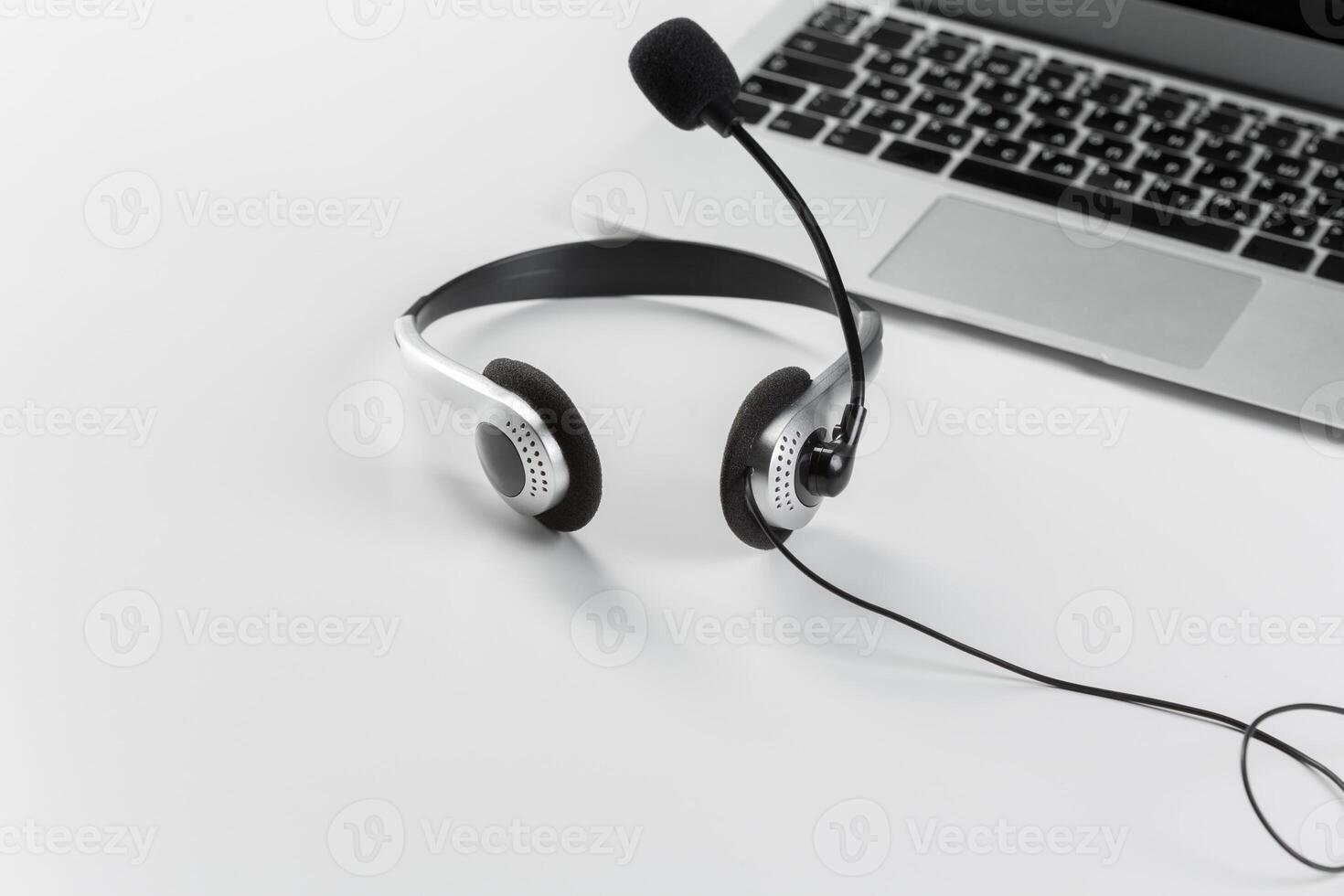 call center support concept. headset on keyboard computer laptop photo