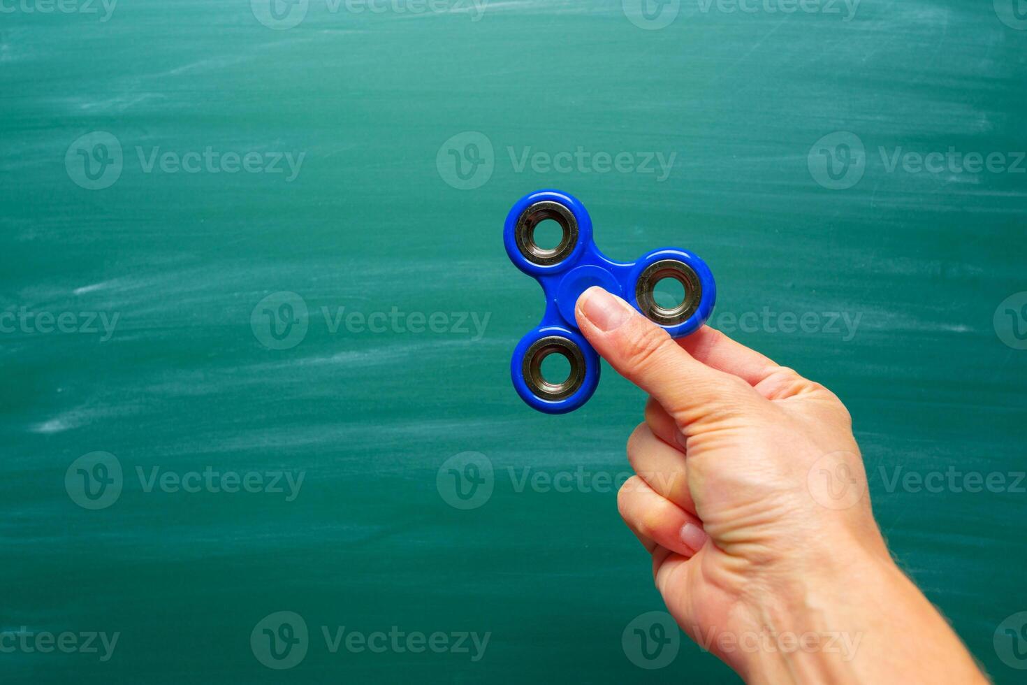 Blue spinner on a green chalkboard background photo