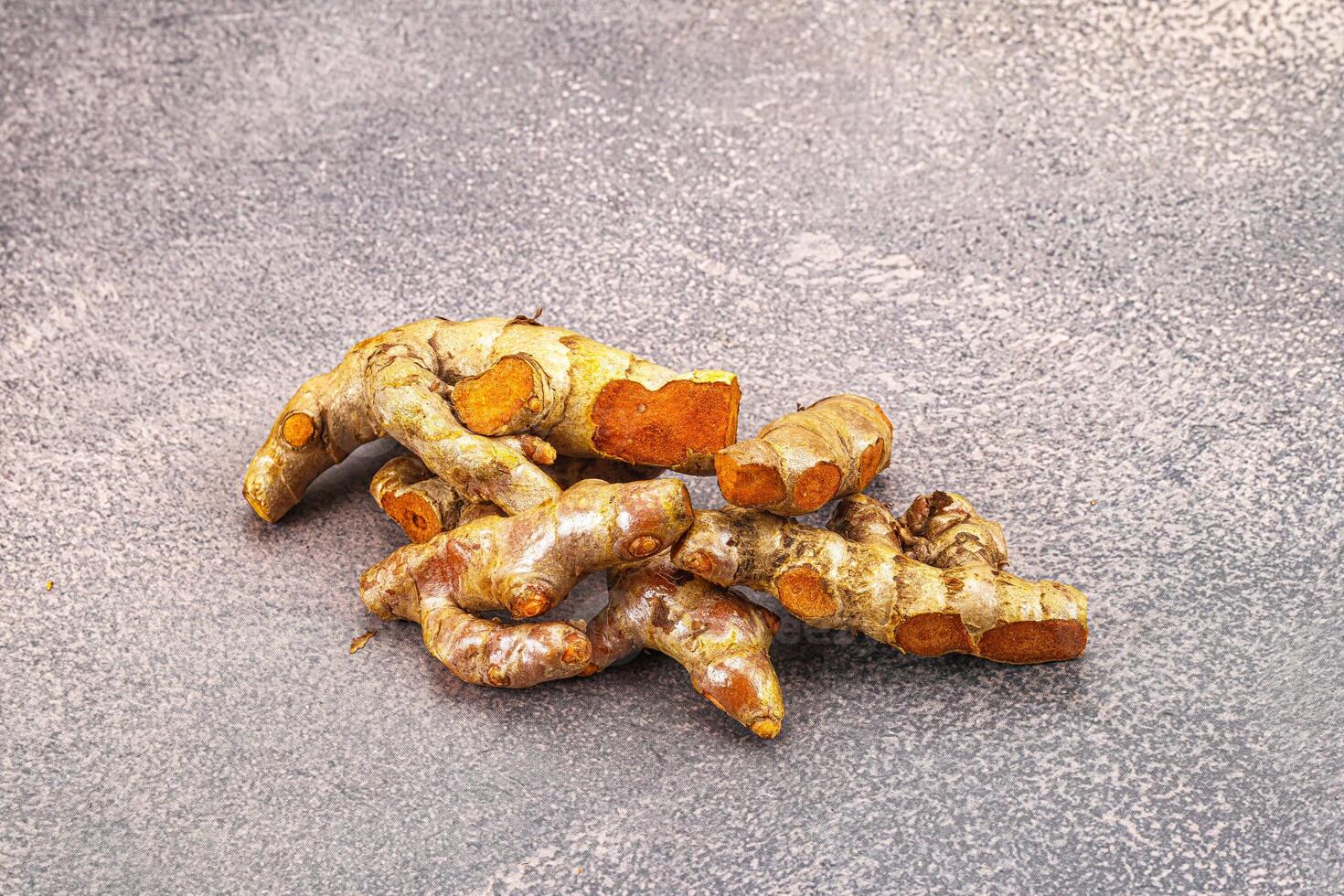 Fresh young Tumeric root heap photo