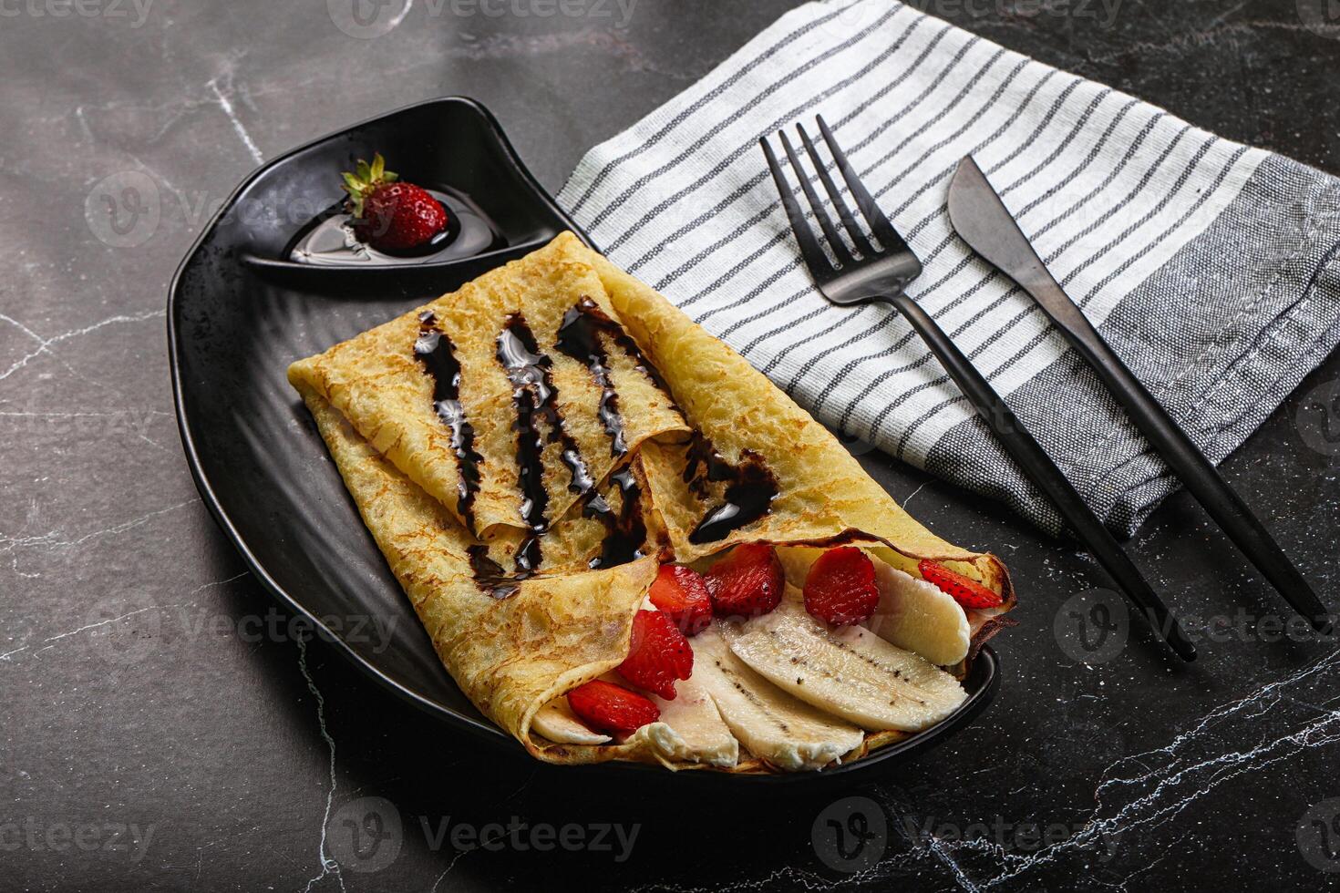 Sweet pancake with banana and strawbeery photo