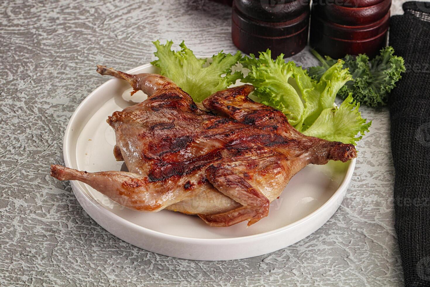Grilled quail in the plate photo