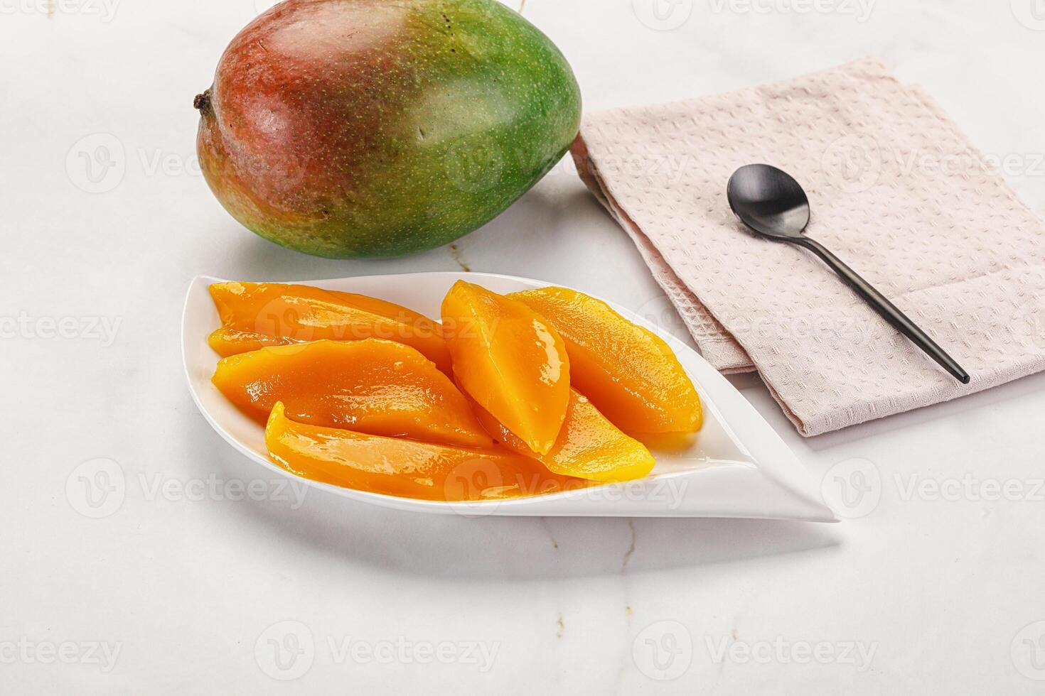 Canned mango slices in the bowl photo