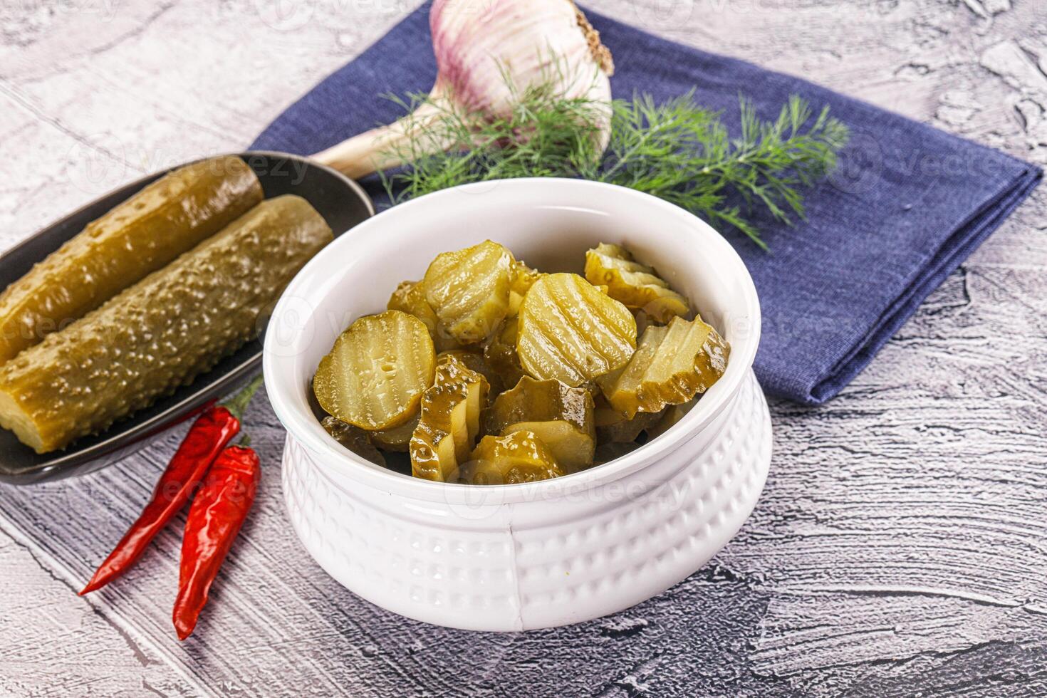 Sliced marinated cucumbers in the bowl photo