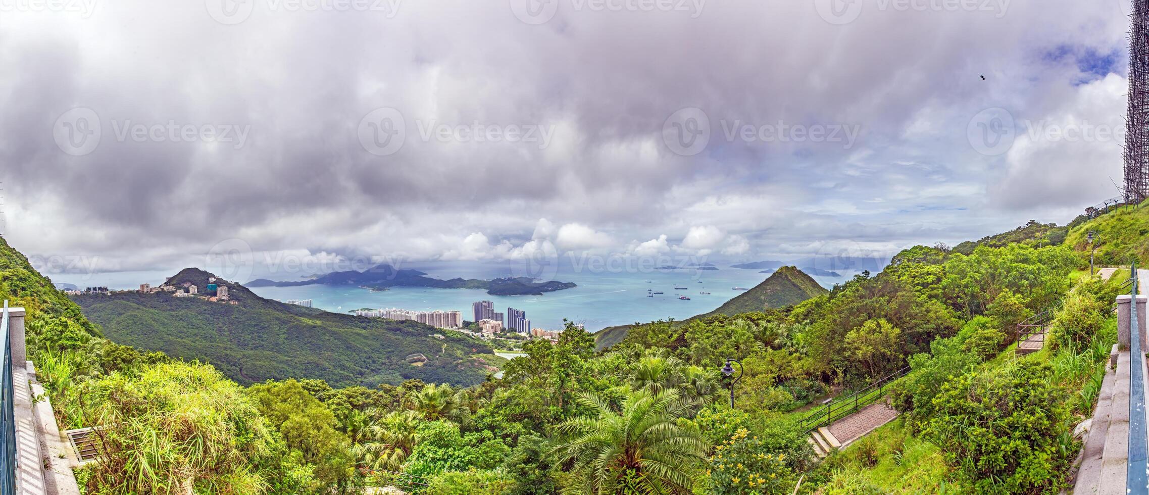 View from Mount Davis showing the passage to Hong Kong harbor, framed by lush green hills and sea photo