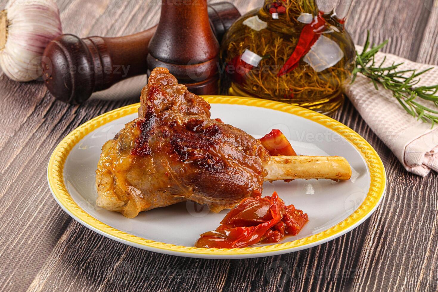 Baked lamb shank with vegetables photo