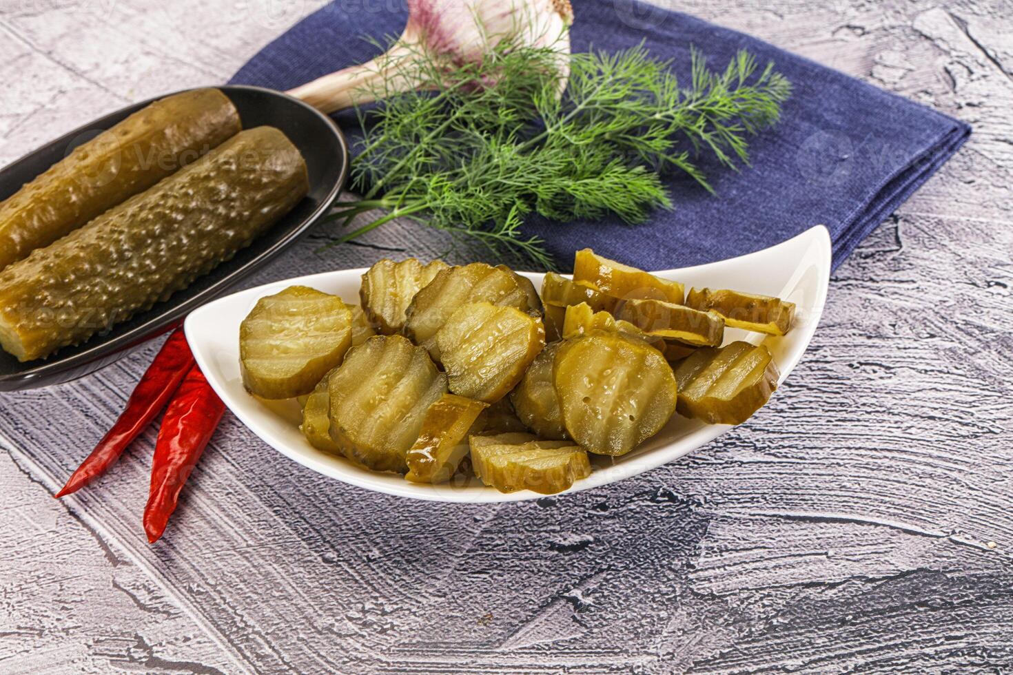 Sliced marinated cucumbers in the bowl photo