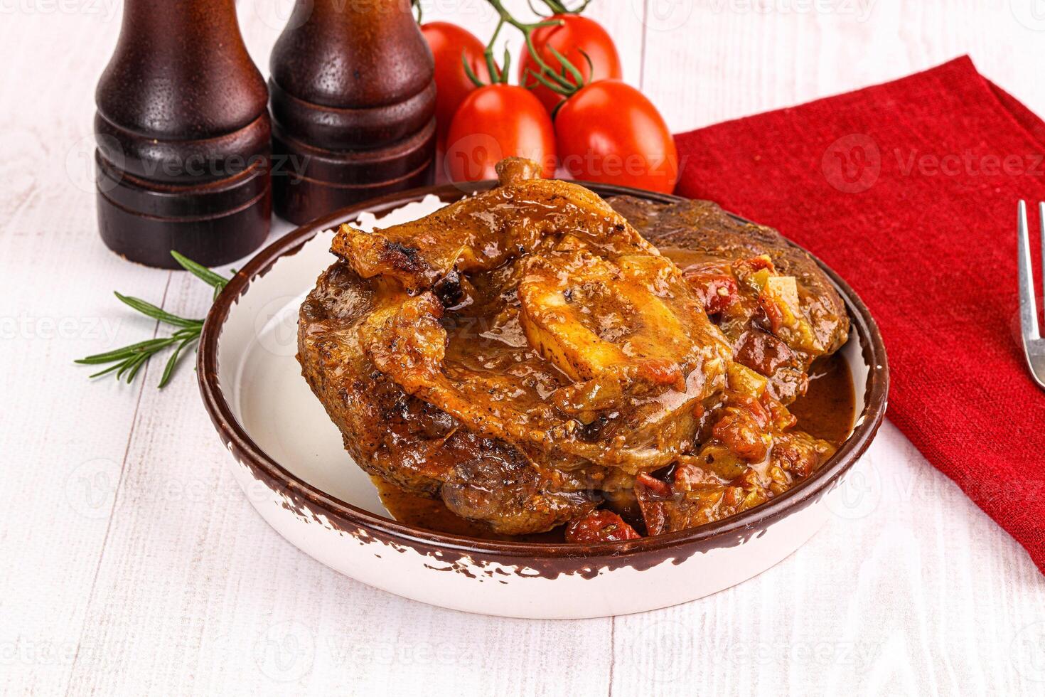 Italian cuisine - ossobuco with sauce photo