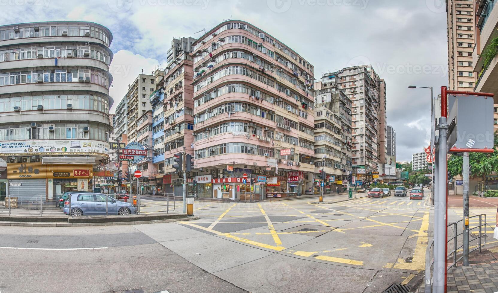 Dense urban architecture in Hong Kong with tightly packed high-rise buildings under a bright sky photo