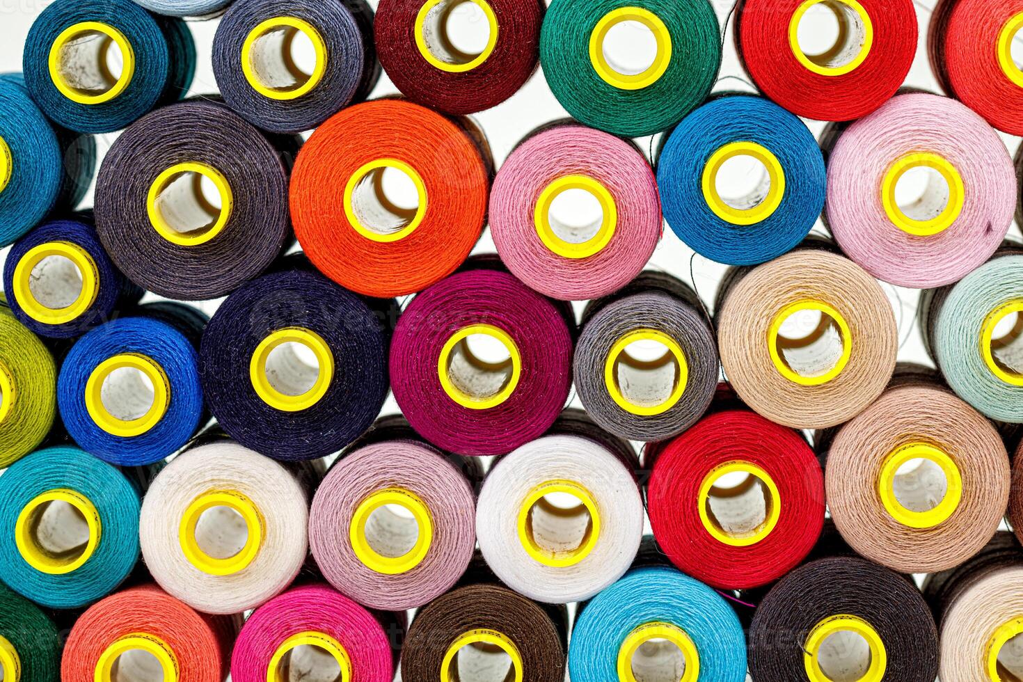 set of multi-colored spools of thread for sewing photo