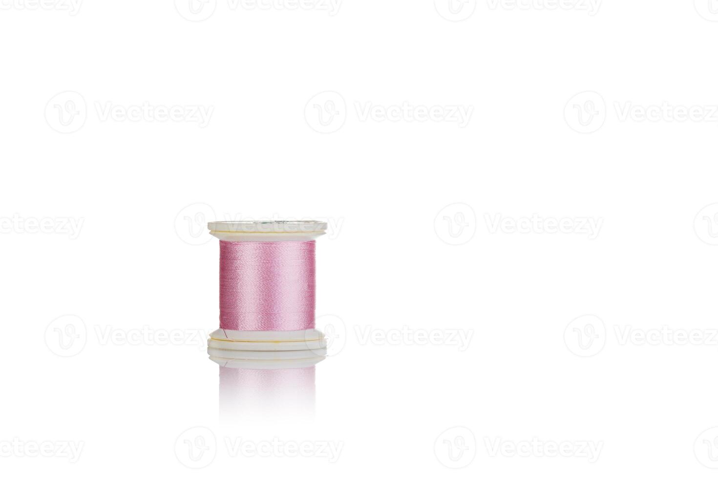 skein of thread pink colors macro on a white background photo