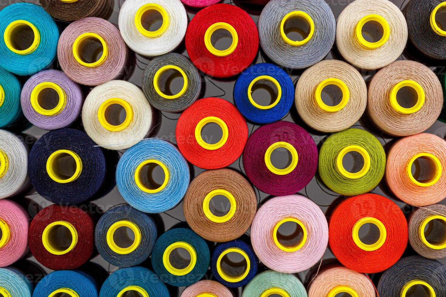 set of multi-colored spools of thread for sewing photo