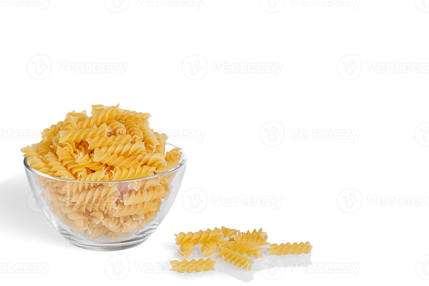 Pasta products in the form of a spiral on a plate, texture, on a white background photo