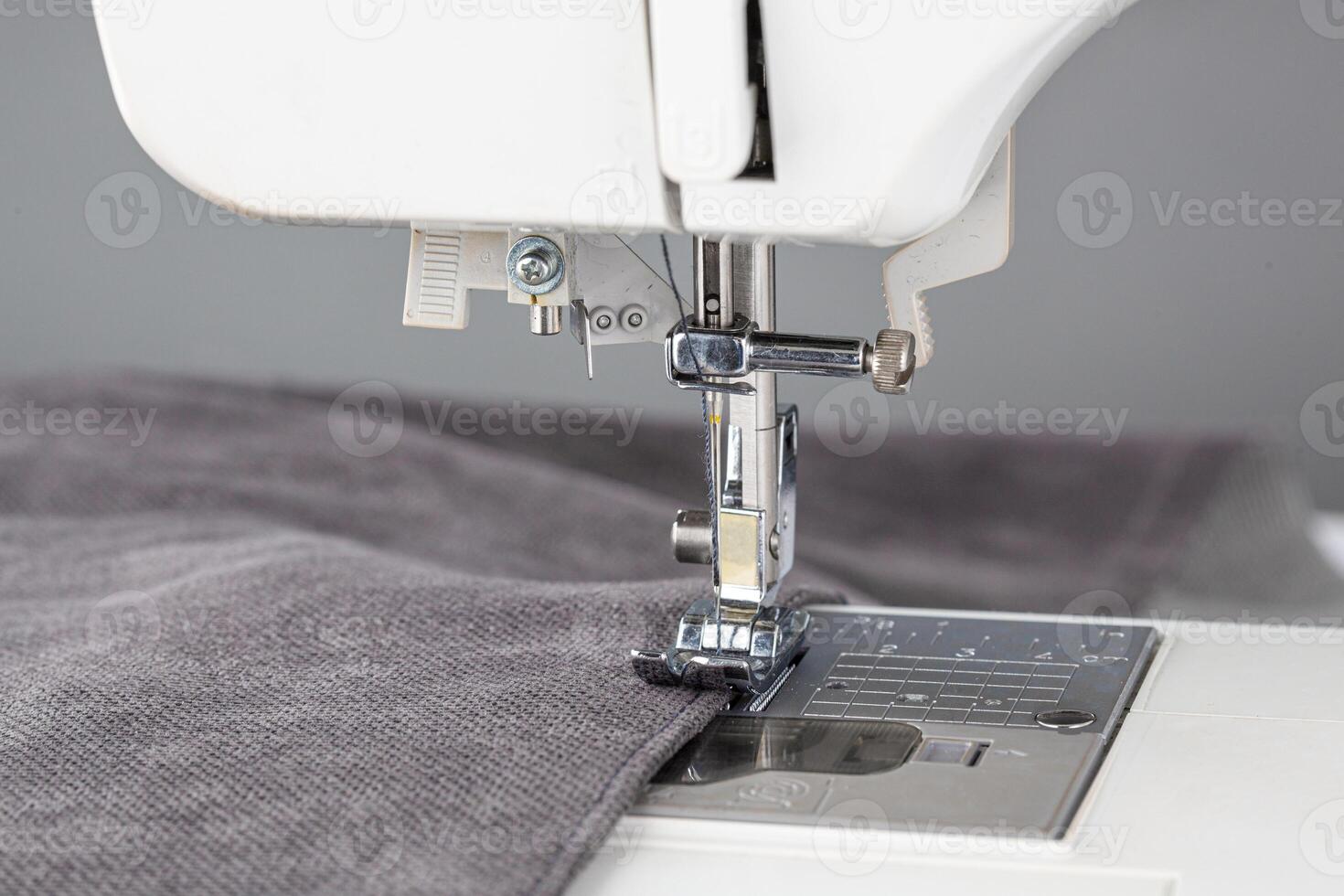 Sewing machine, stitching fabrics, needle in a round plan photo