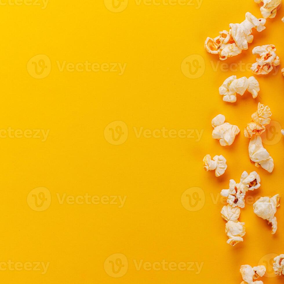 box with popcorn on a yellow background photo
