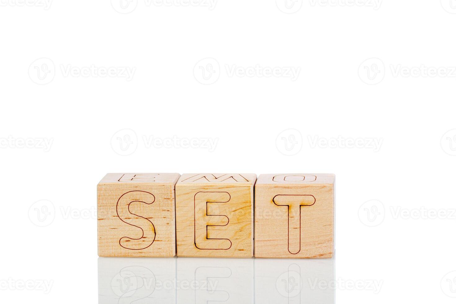 Wooden cubes with letters set on a white background photo