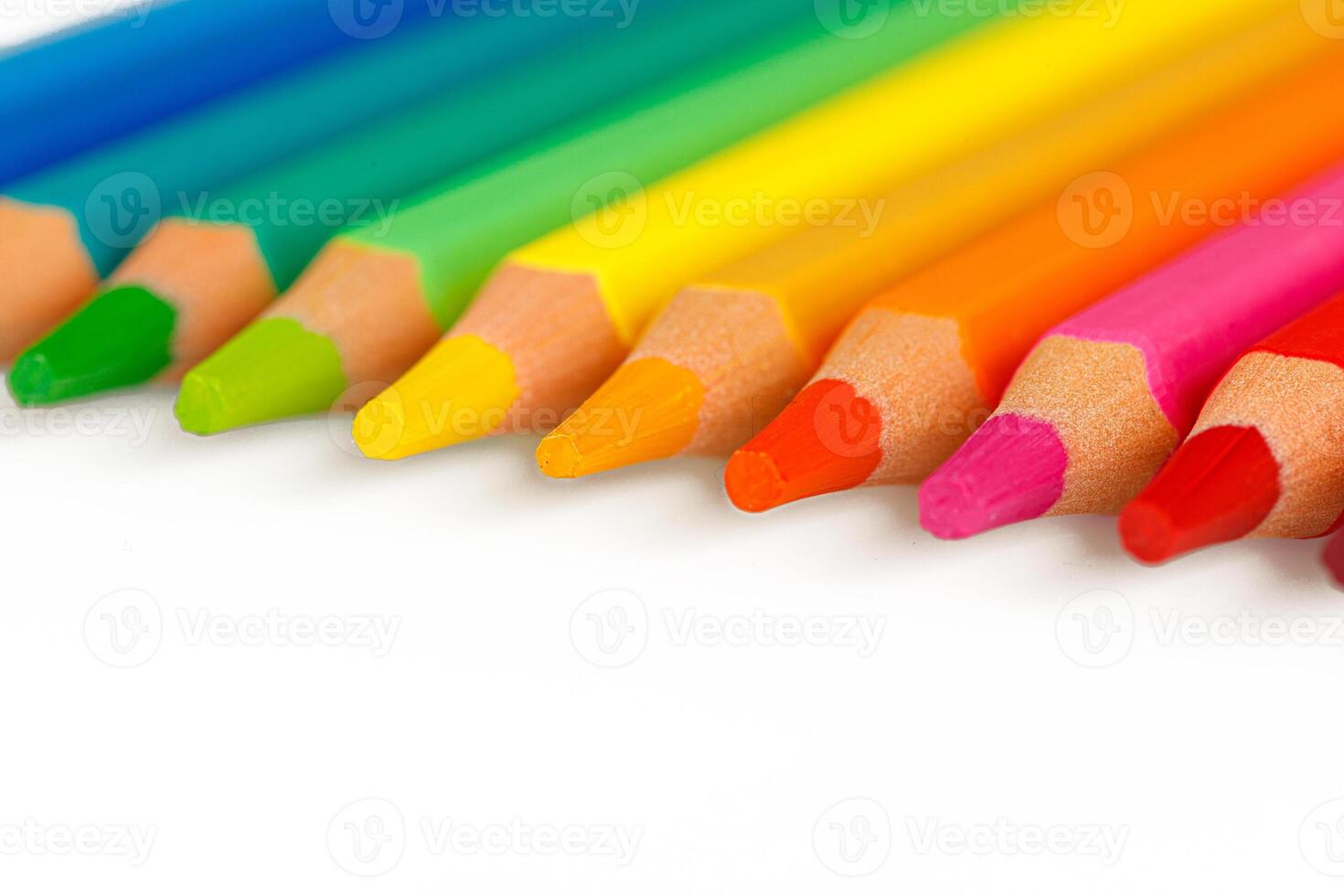 set of multi-colored pencils on a white background photo