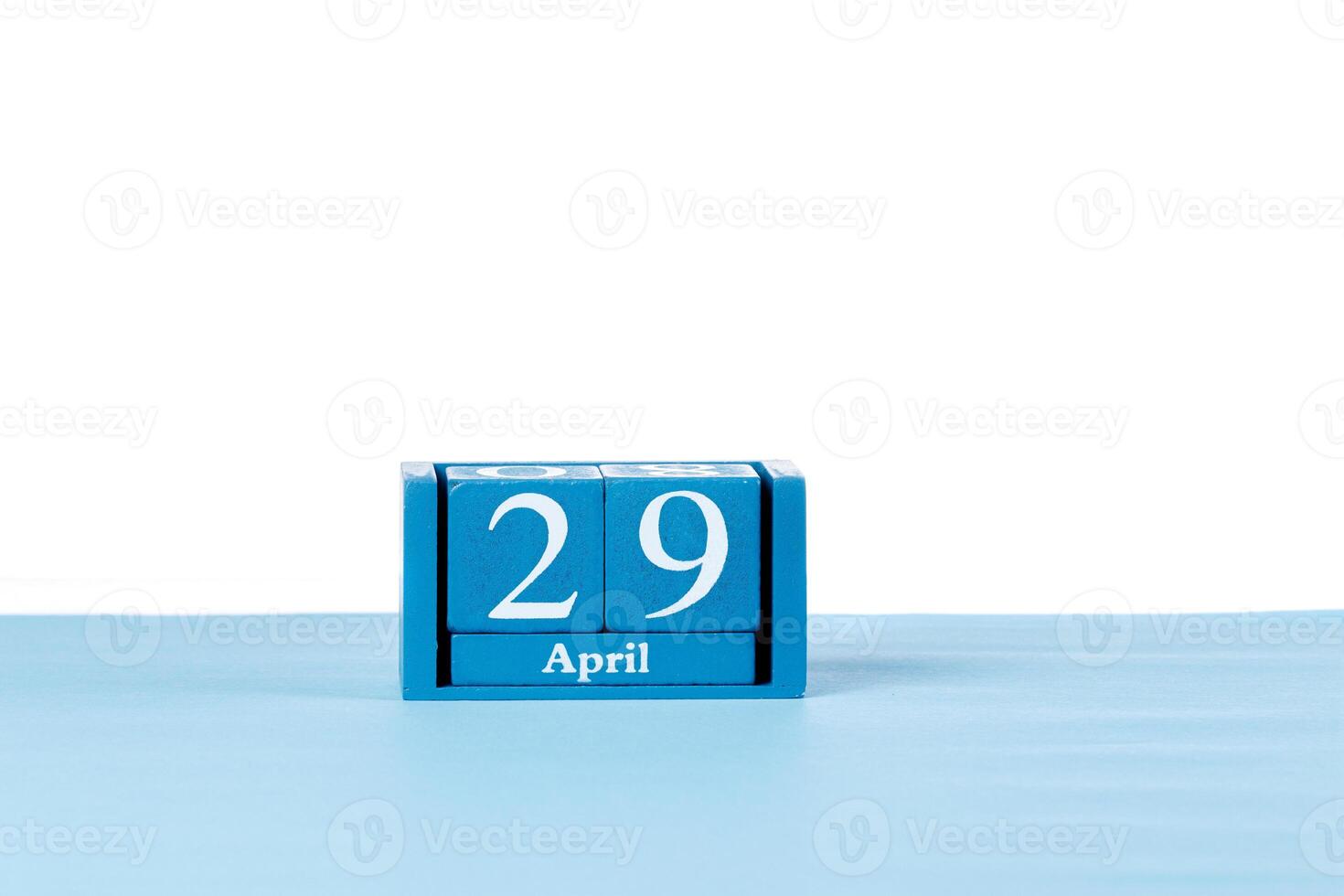 Wooden calendar April 29 on a white background photo