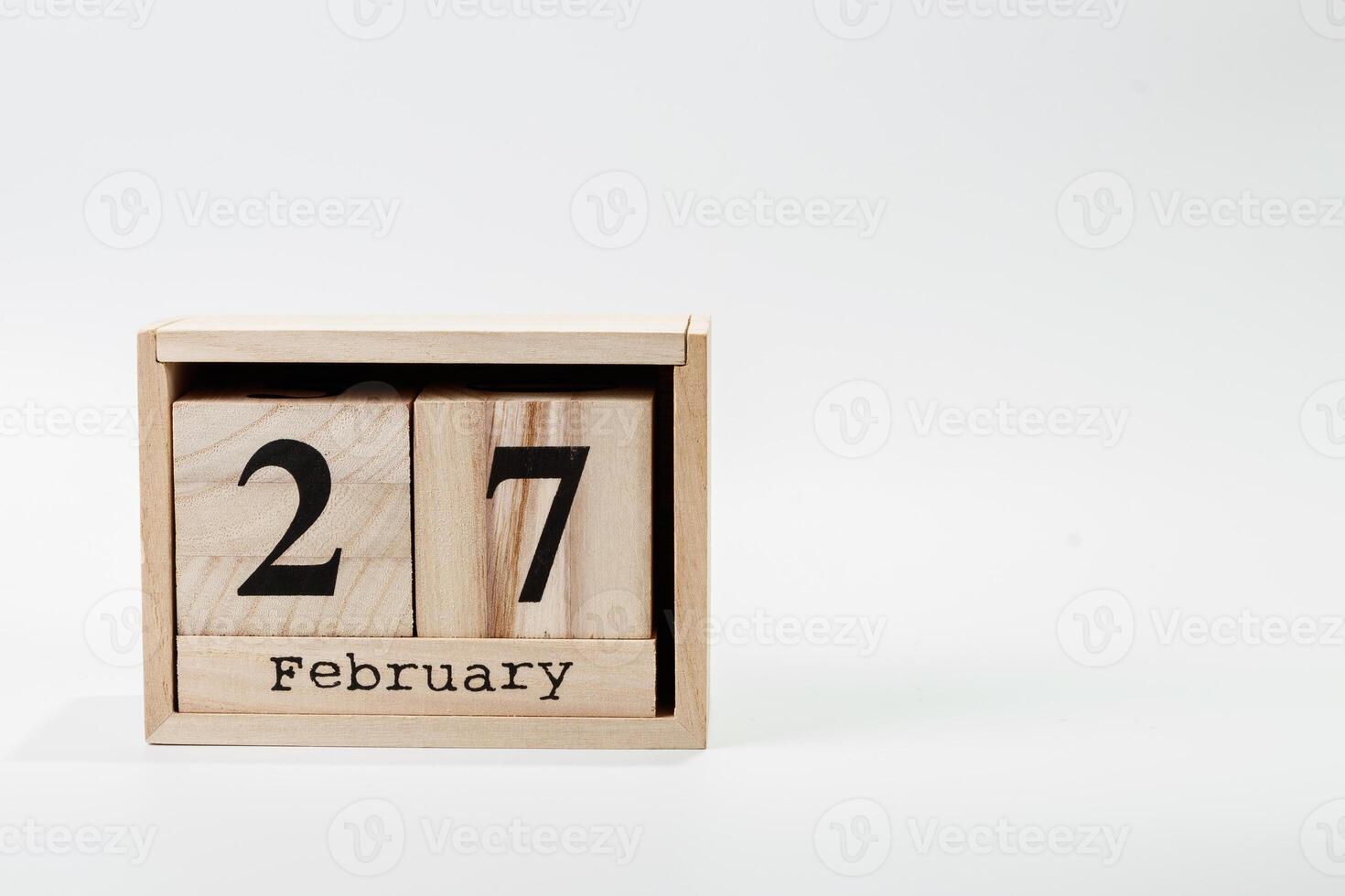 Wooden calendar February 27 on a white background photo