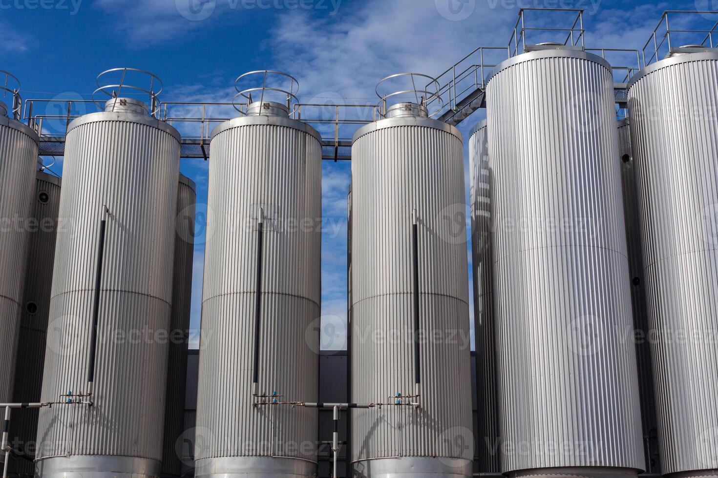 Giant industrial tanks on the bright blue sky photo