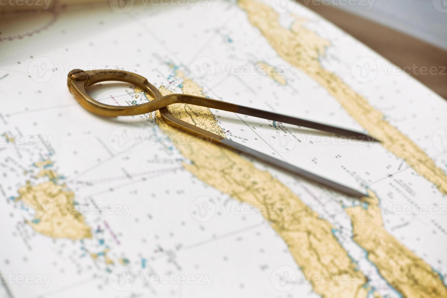 Pair of compasses for navigation on a sea map photo