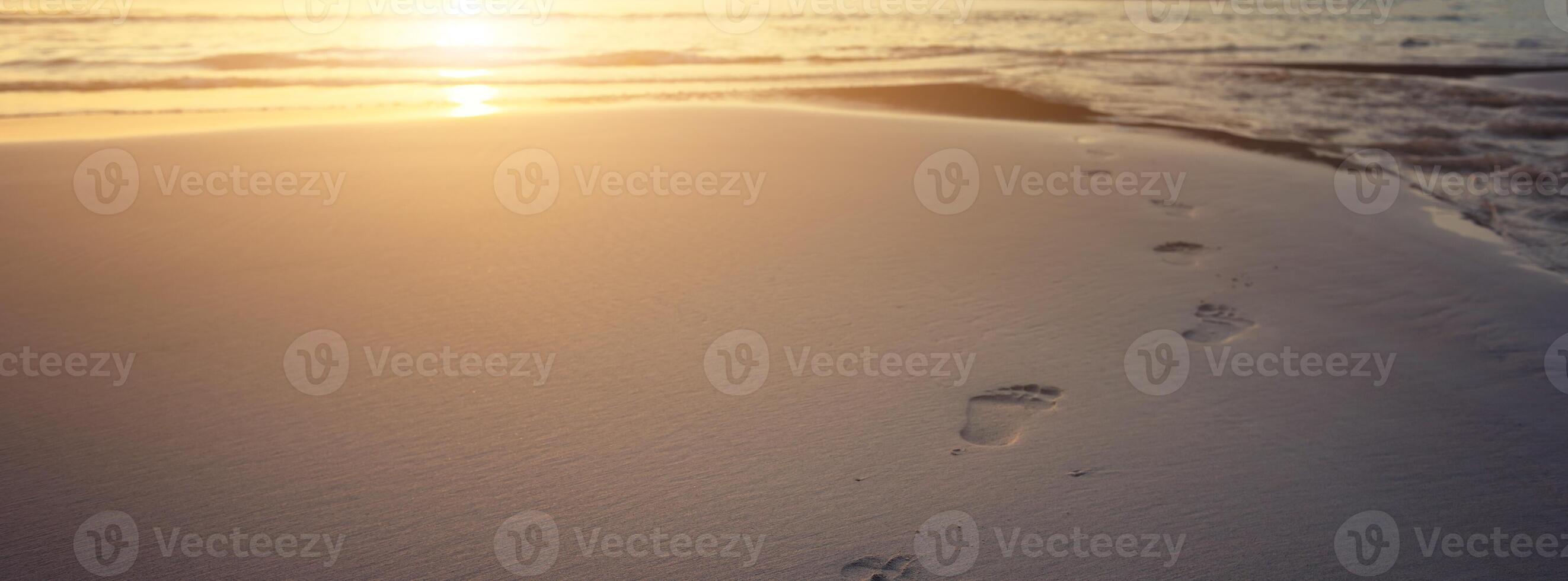 Human footprints on beach sand photo