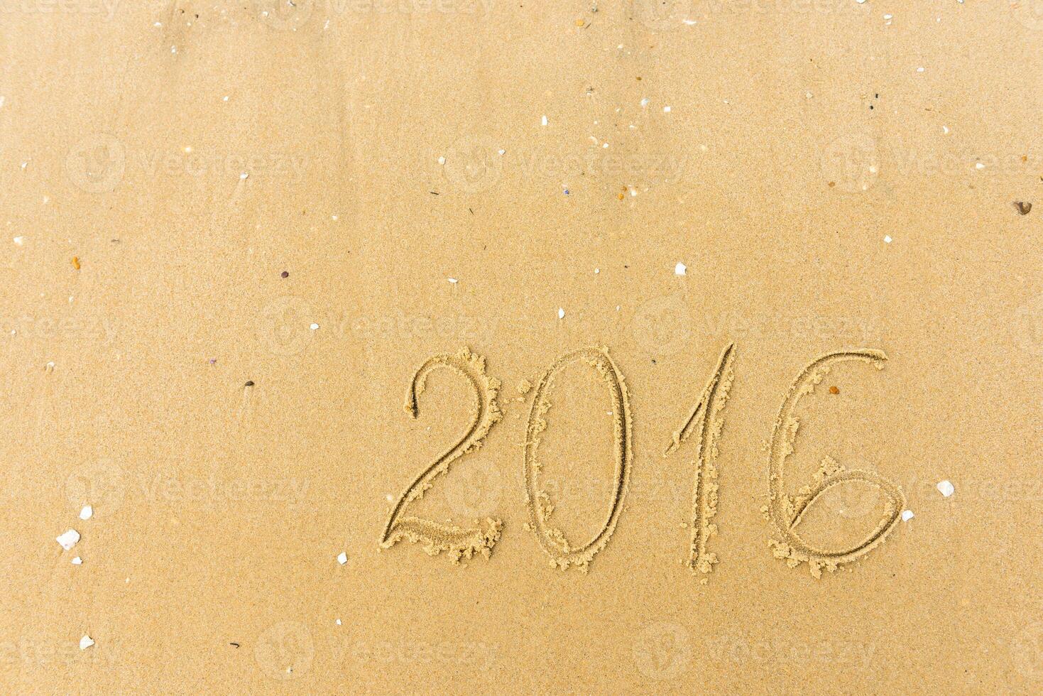 2016 Year written on the beach sand photo
