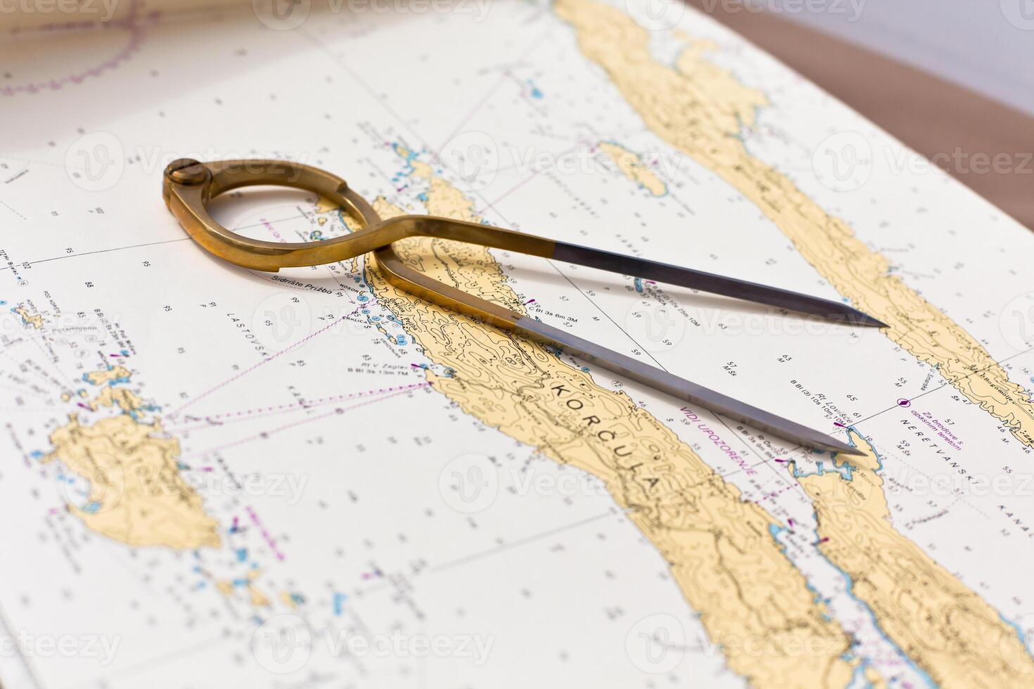 Pair of compasses for navigation on a sea map photo