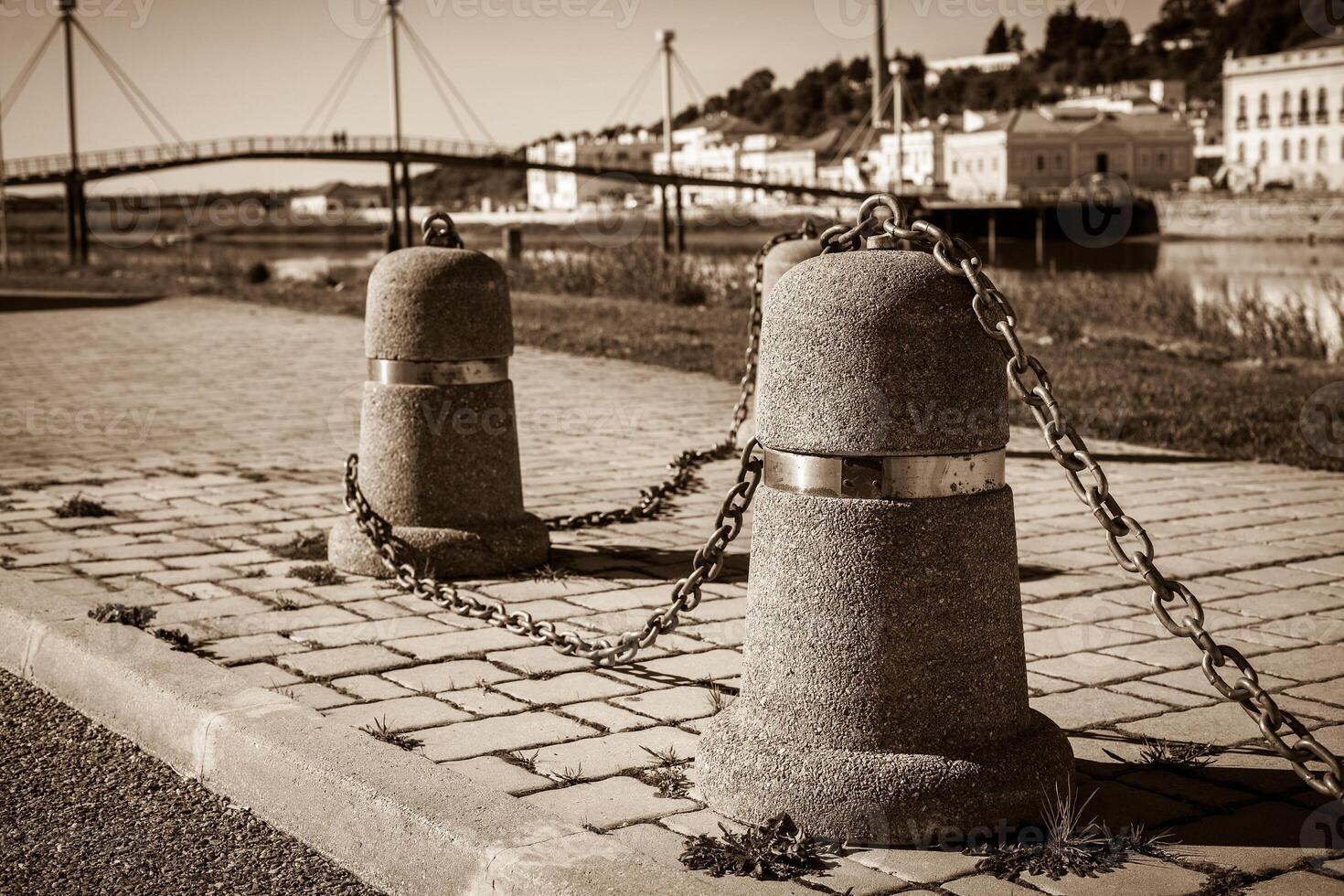 Stub posts linked in a chain on a quay photo