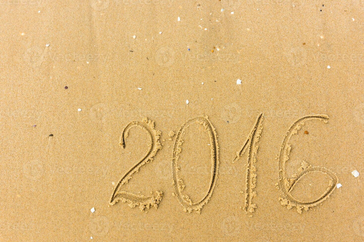 2016 Year written on the beach sand photo