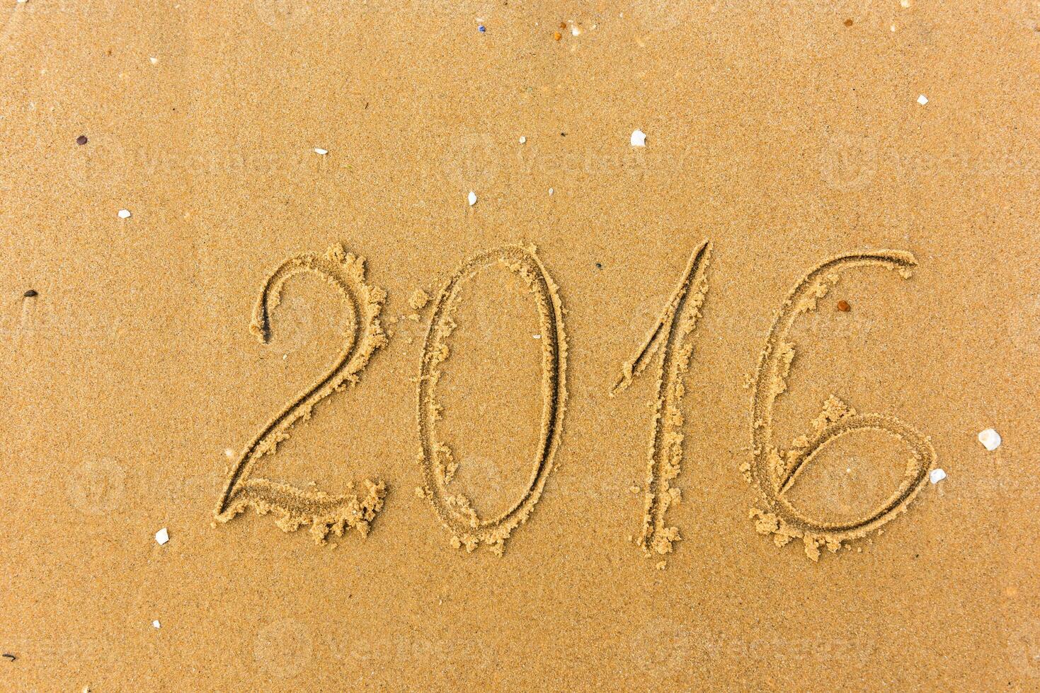2016 Year written on the beach sand photo