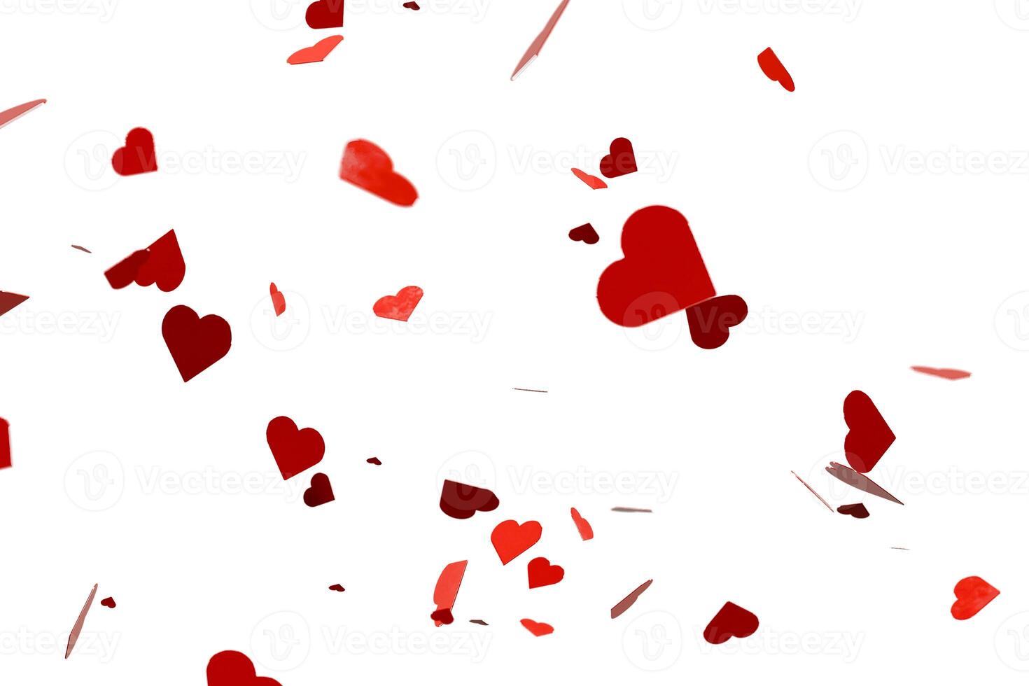 Heart shaped red confetti overlay on white background photo