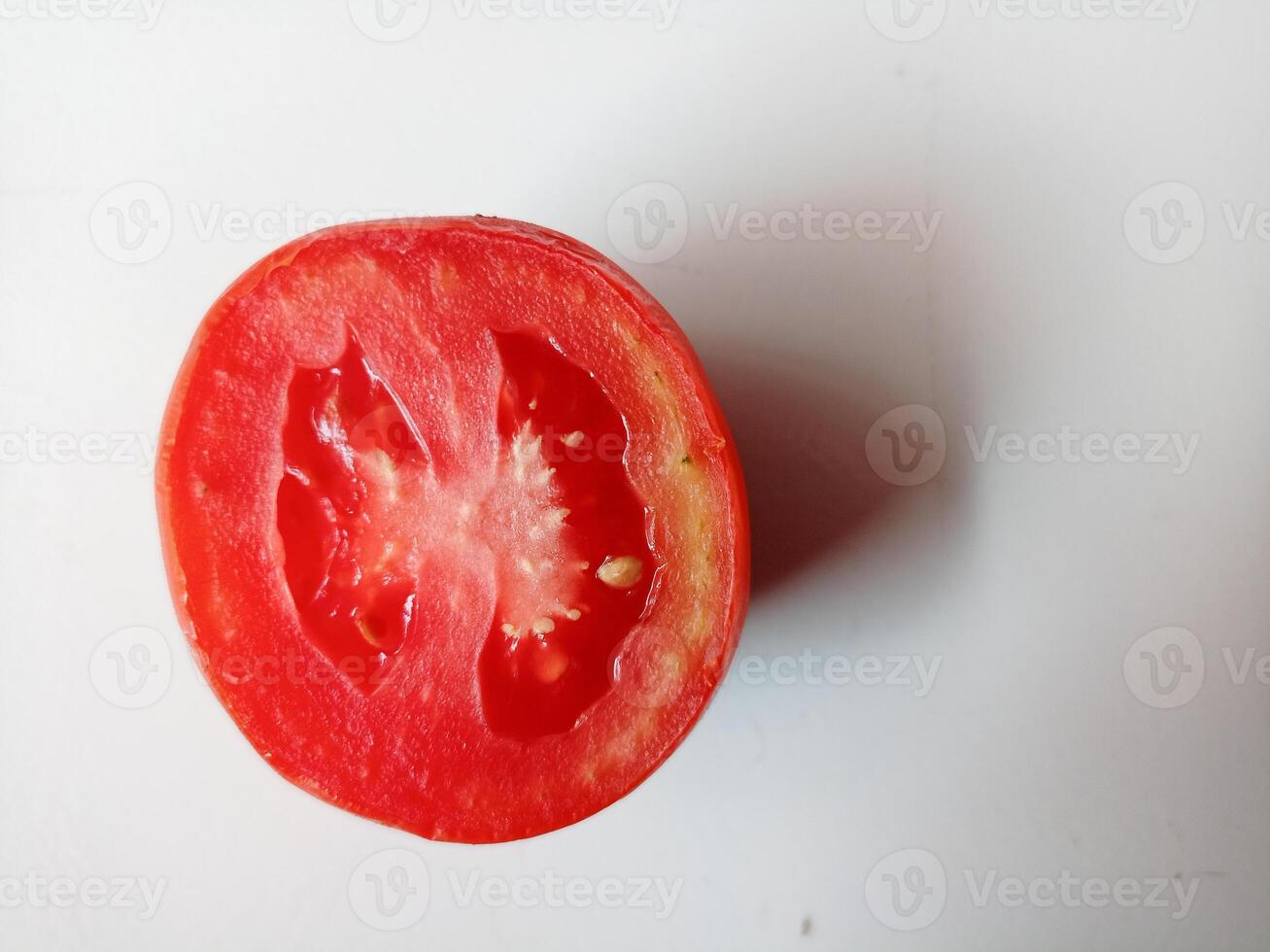 Half of fresh cherry tomato isolated on white background photo