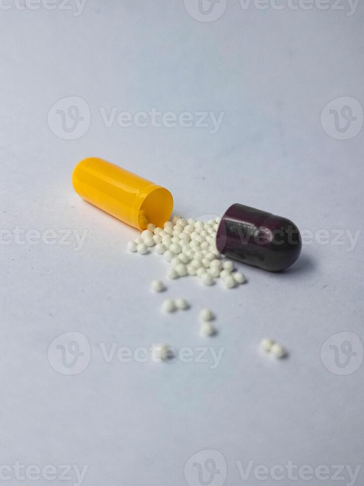 Capsules and granules of omeprazole isolated on white background photo