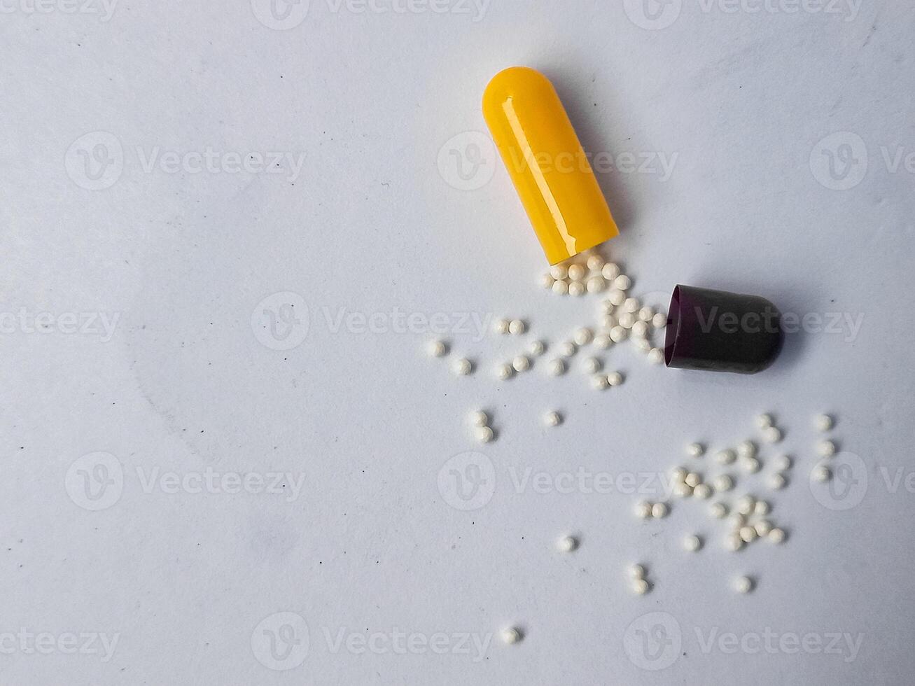 Capsules and granules of omeprazole isolated on white background photo