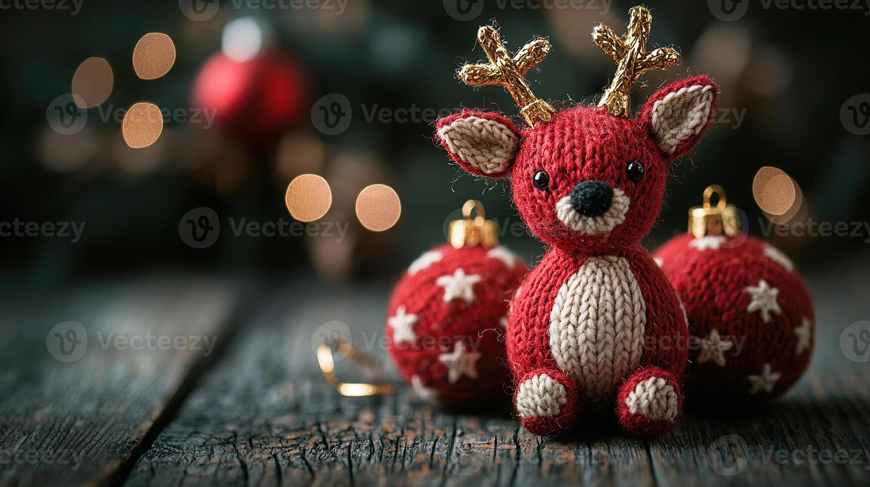 A red and white knitted reindeer is sitting on a wooden table photo