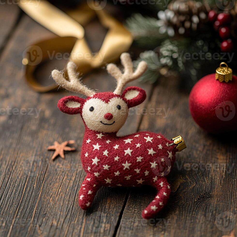 A red felt reindeer ornament on a wooden table photo